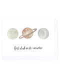 Greeting card with planets and 'best dad in the universe' text on a white background
