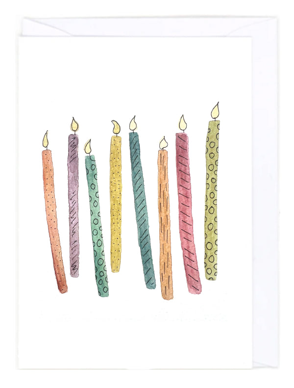 Greeting card with colorful birthday candles on a white background