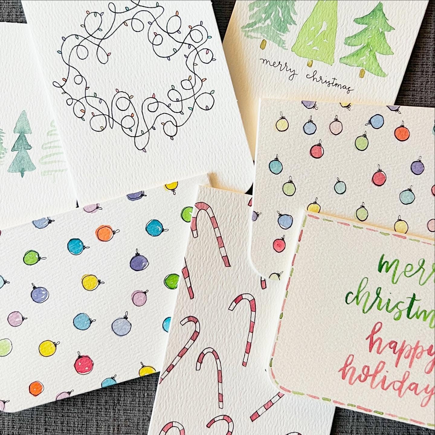 Collection of Christmas-themed hand-painted greeting cards with various designs.