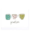 Card with three colorful teacups with a 'get well soon' message on a white background.