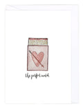 Greeting card with a matchbox with a heart and arrow design and text 'the perfect match' on a white background