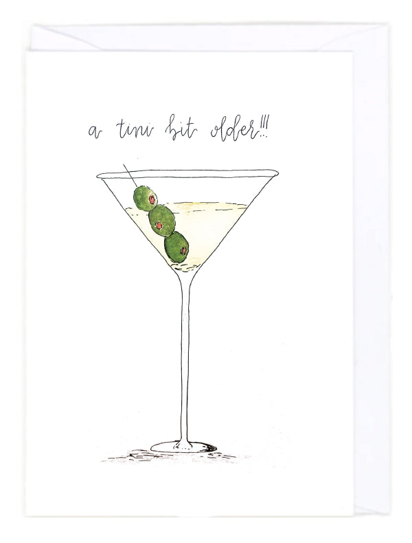 Greeting card with an illustration of a martini glass with olives and text 'a tini bit older!!!' on a white background