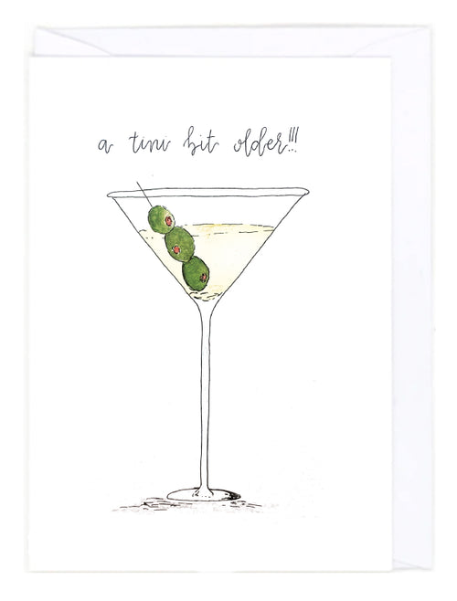 Greeting card with an illustration of a martini glass with olives and text 'a tini bit older!!!' on a white background