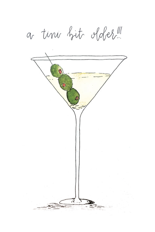 Illustration of a martini glass with olives and text 'a tini bit older!!!' on a white background
