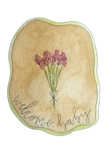 Decorative sign with flowers and 'welcome, hygge' text on a beige background